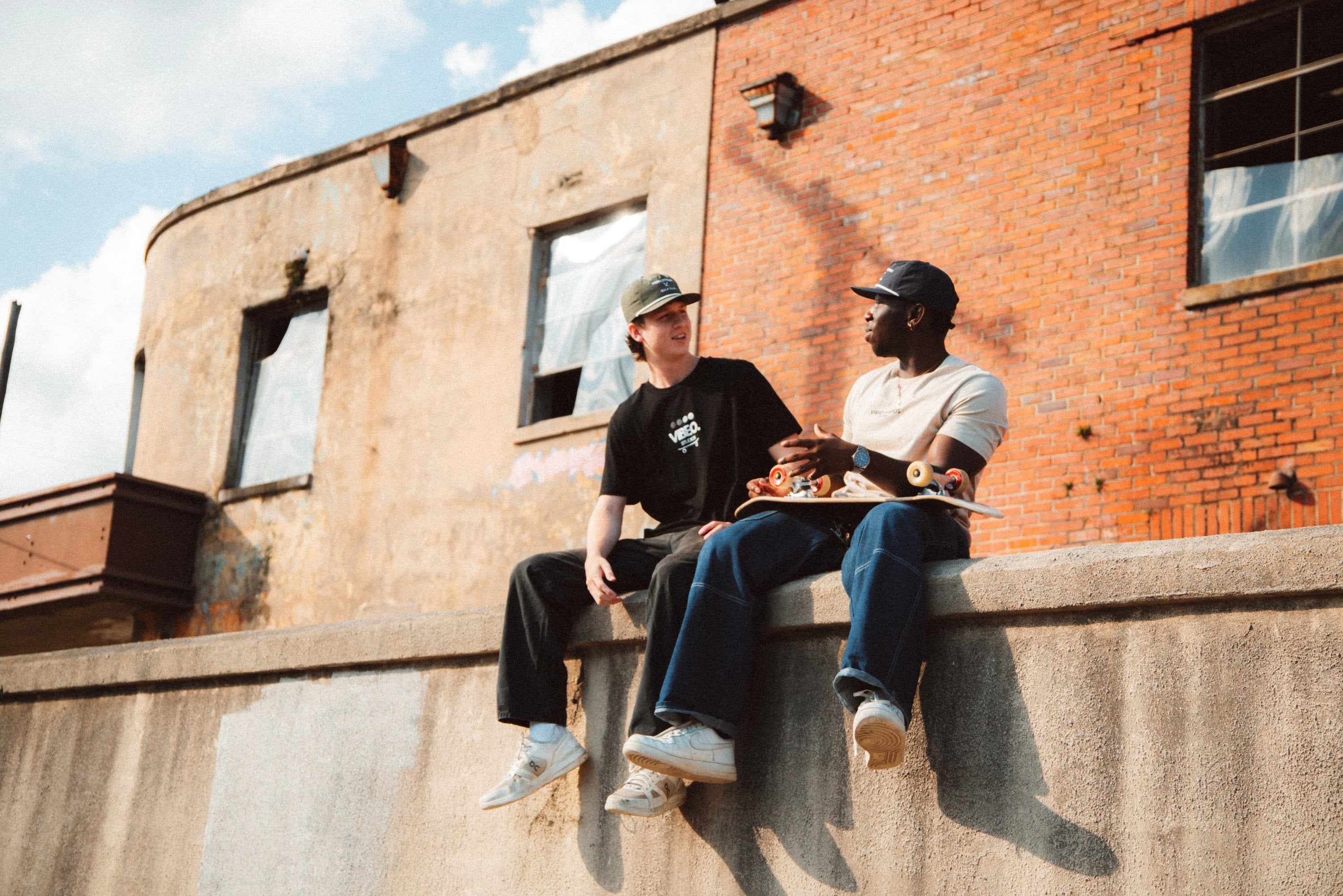 Two Guys Talking While Wearing VIBEOSTUDIOS Organic/Recycled Apparel